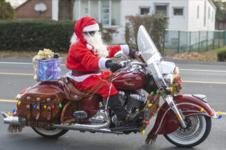 Santa Rides Indian Motorcycle to Deliver Christmas Gifts to Orphans